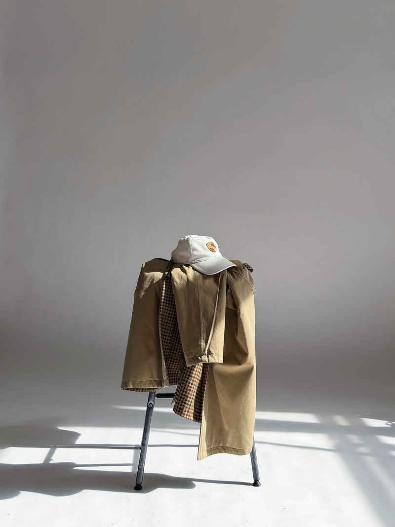 Khaki jacket and cap resting on a chair